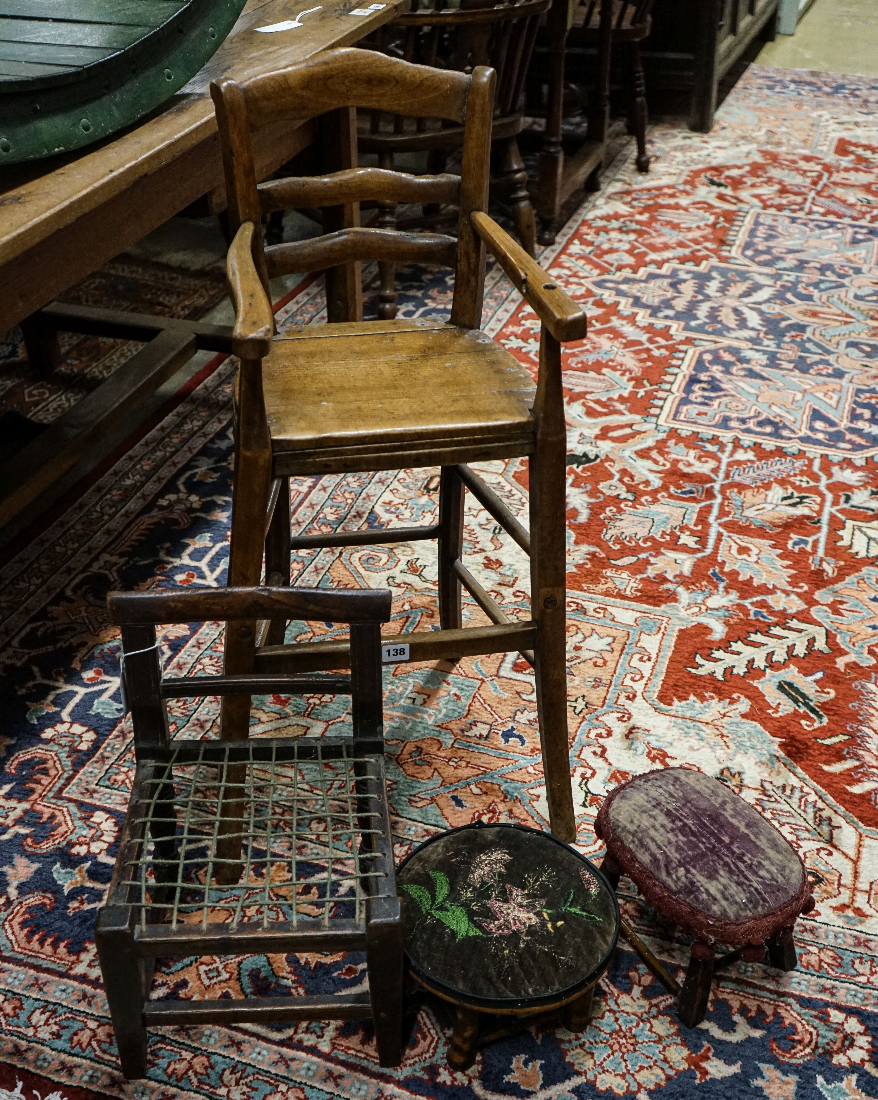 An early 19th century primitive mahogany child's chair, with strung seat, height 29cm, a beech high chair, height 85cm and two small child's stools